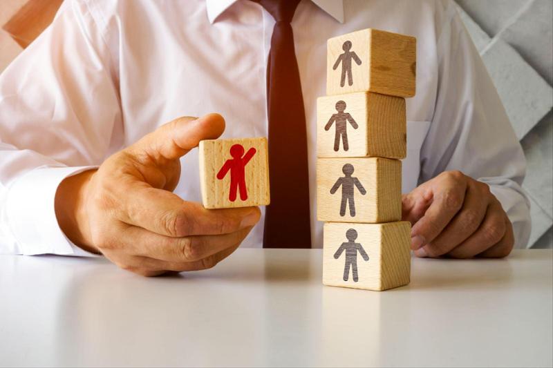 man in white collar shirt playing with kids blocks depicting people