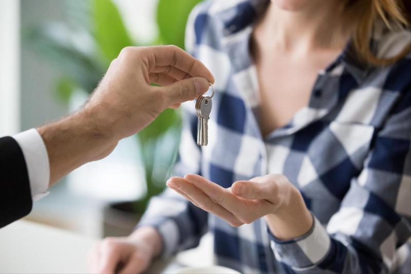 woman being handed keys