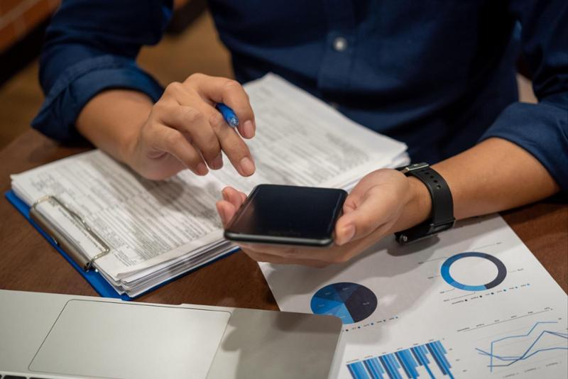 man doing taxes holding a calculator